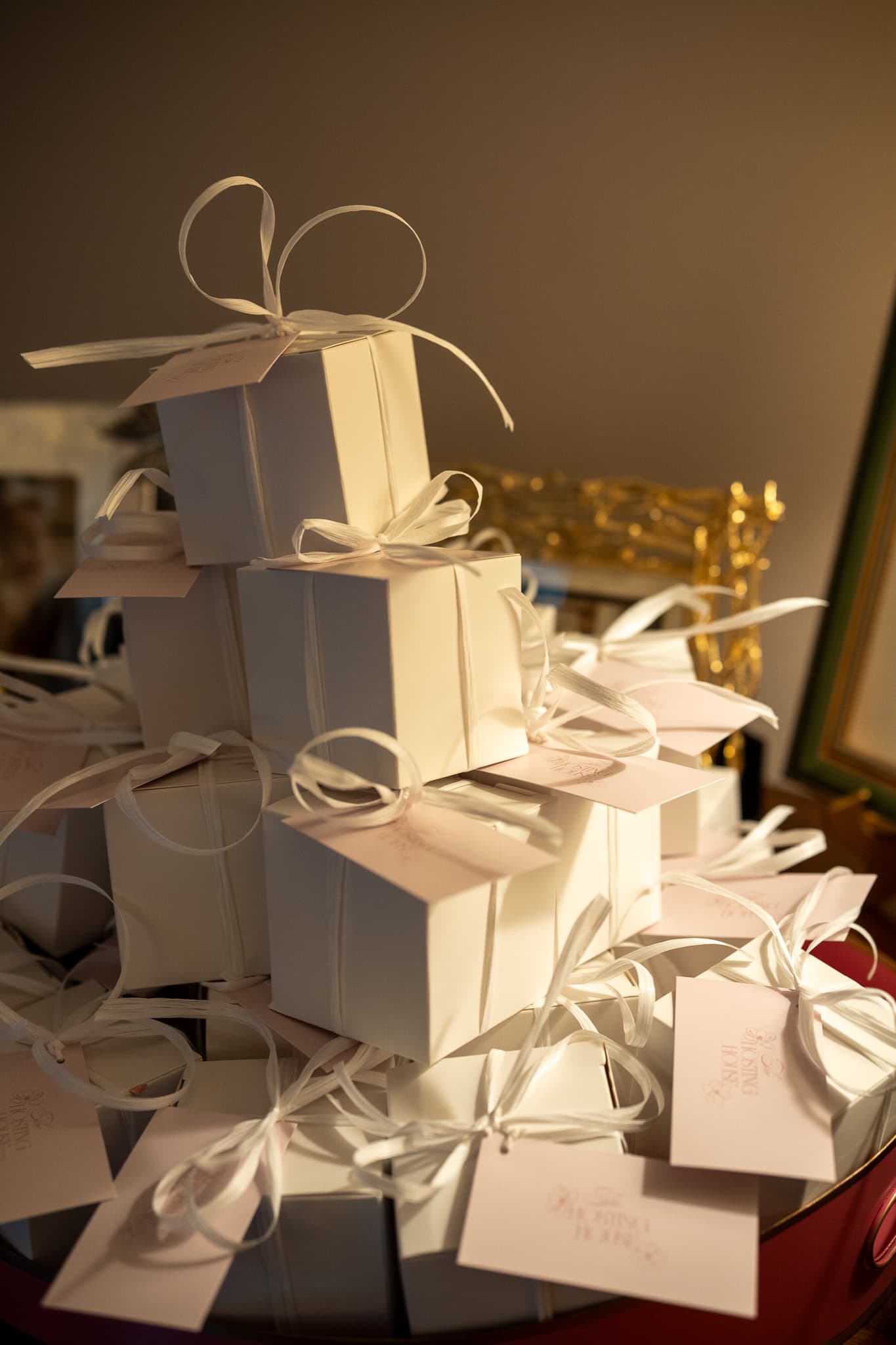 Branded white gift boxes with ribbons and The Hosting House tags