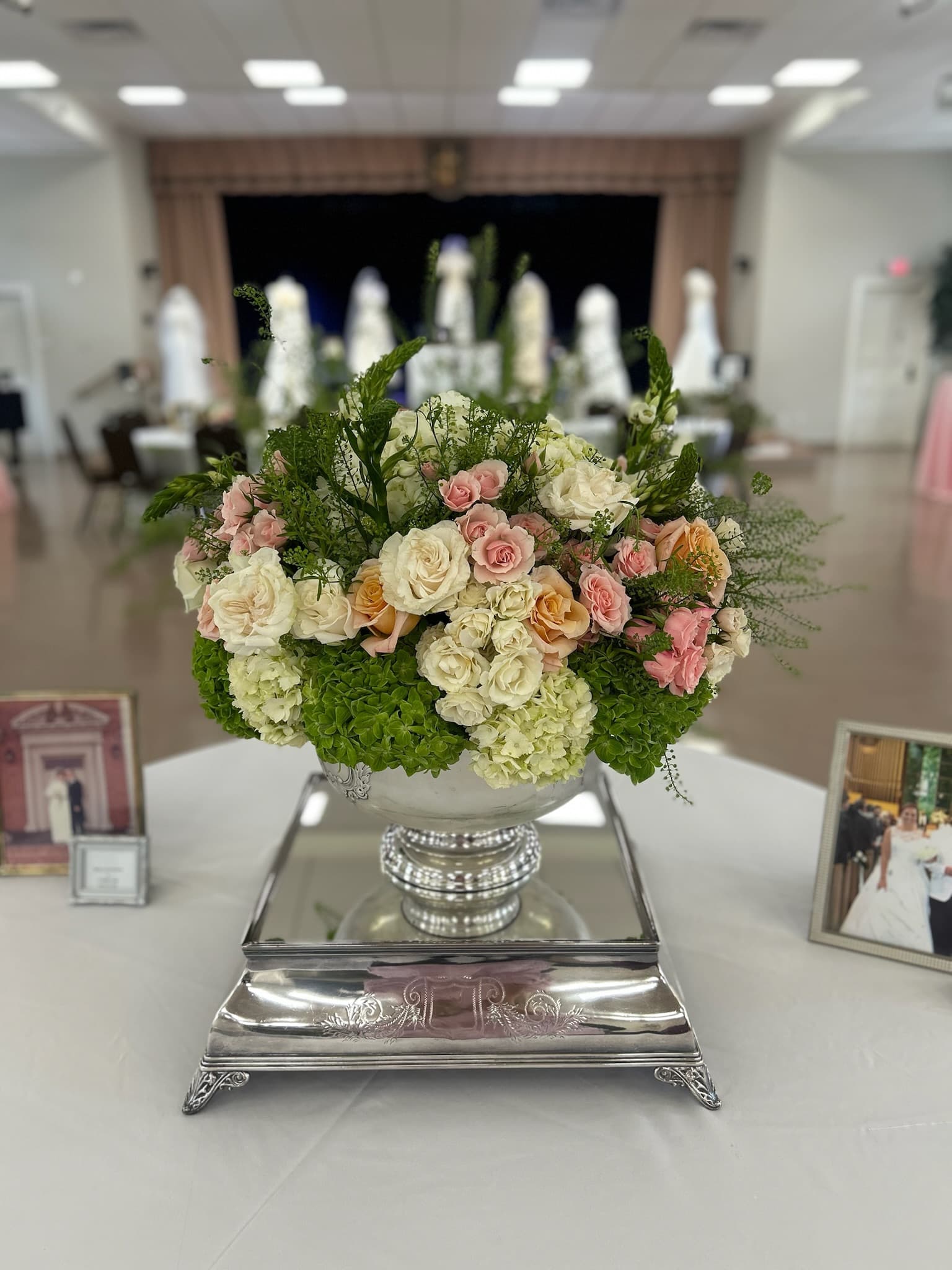 Silver urn with roses and florals by The Hosting House NC