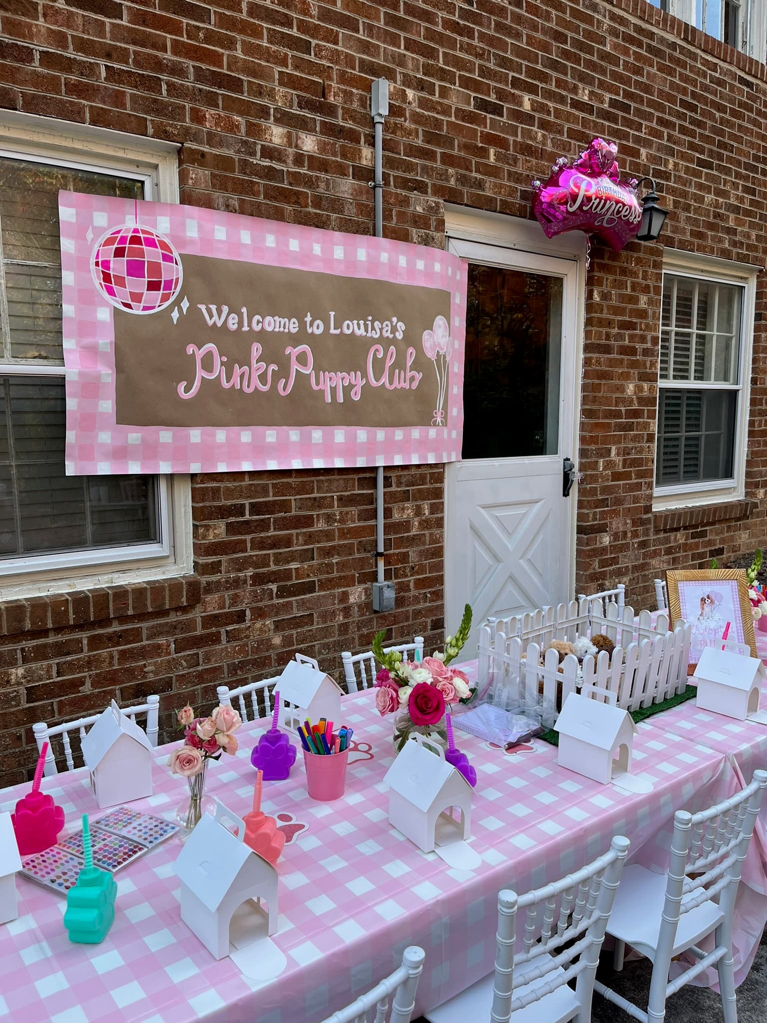 Louisa's Pink Puppy Club kids birthday party with banner and pink table