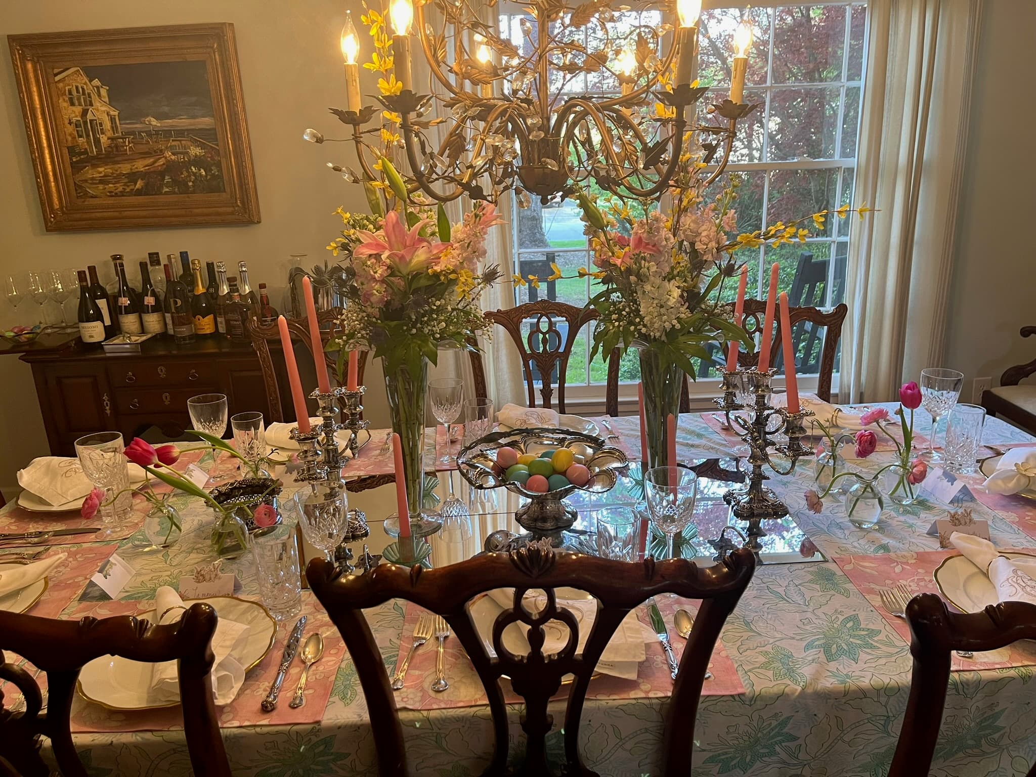 Spring dining table with tall floral arrangements and tapers